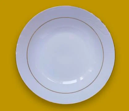 Empty white plate on a yellow table.View from above Stock Photos