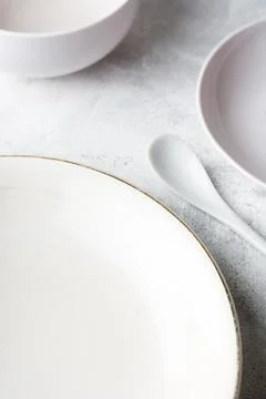 Empty white plates and cup with a spoon Stock Photos