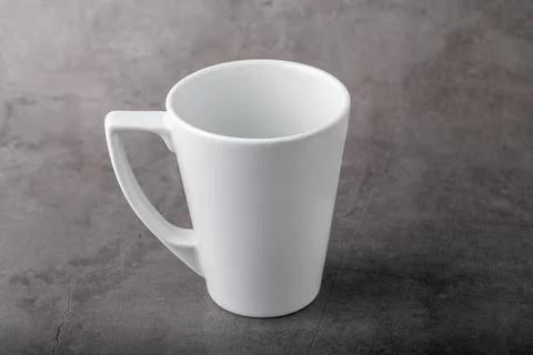 Empty white porcelain cup on gray stone background Stock Photos