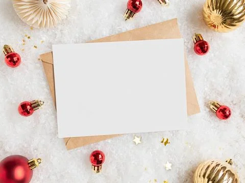 Empty white postcard and craft envelope and various christmas decor on arti.. Stock Photos