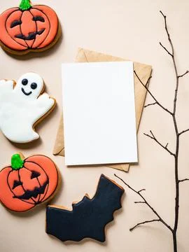 Empty white postcard and craft envelope and Halloween gingerbread cookies - J Stock Photos