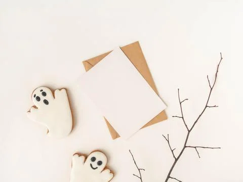 Empty white postcard and craft envelope and Halloween gingerbread cookies g.. Stock Photos