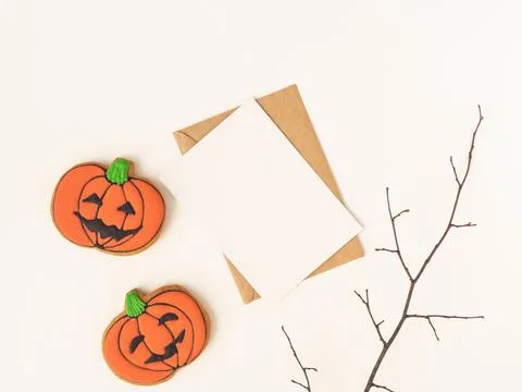 Empty white postcard and craft envelope and Halloween gingerbread cookies J.. Stock Photos
