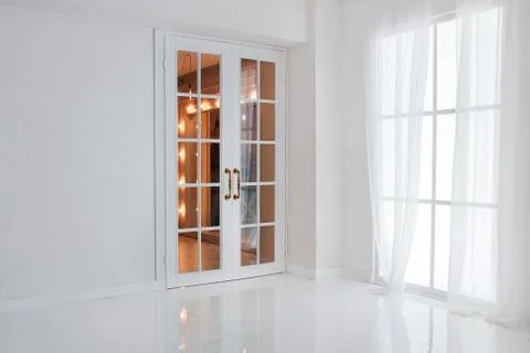 Empty white room with big window and glass french door with bright orange lig Stock Photos