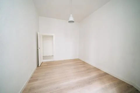 An empty white room with one door. Stock Photos