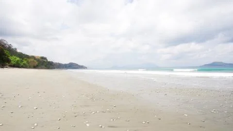 Empty white sand beach and clear blue ocean waves at Bajawa Ruting Flores. Stock Photos