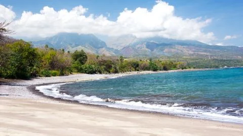 Empty white sand beach and clear blue ocean waves at Bajawa Ruting, Flores. Stock Photos