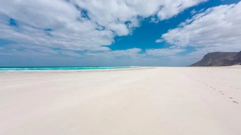 Empty white sand beach with blue sea and clouds. Socotra, Yemen. Stock Photos