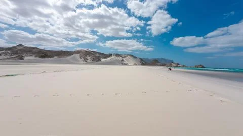 Empty white sand beach with dunes and blue sea Stockfoto's