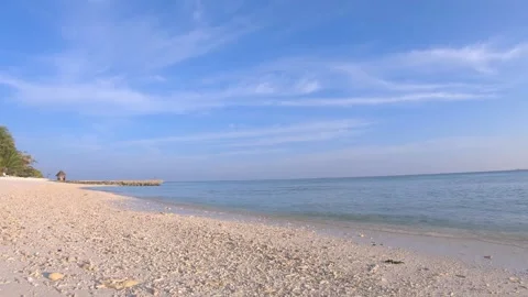 Empty white sand beach, gentle sea waves and light blue sky in Maldives Stock Footage 297458809