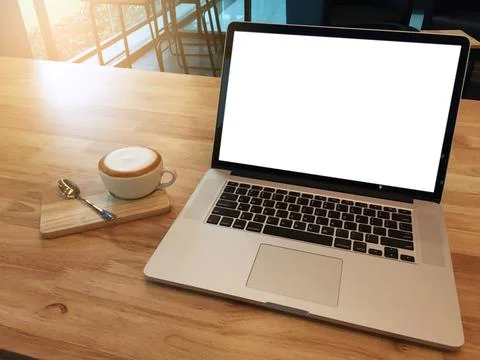 Empty white screen laptop computer for information and coffee cup on wooden.. Stock Photos