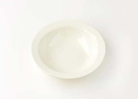 Empty white shallow bowl on clean surface Stock Photos