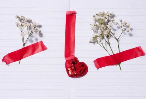 Empty white sheet of paper and gypsophilia flowers on a beige background, s.. Stock-Fotos