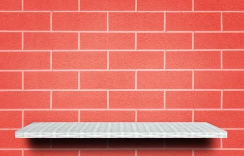 Empty white shelf on red brick background for product display 库存照片