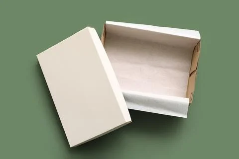 Empty white shoebox on green background Stock Photos