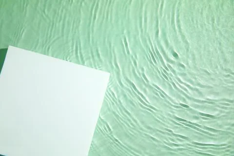 Empty white square podium on transparent green clear water background Stock Photos