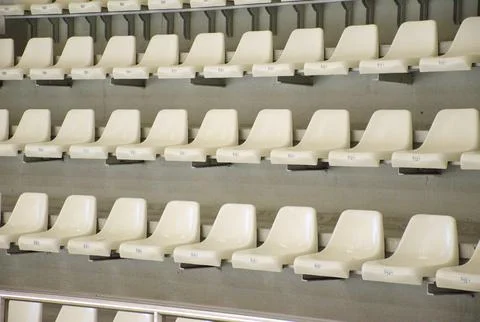 Empty white stadium seats in rows indoor stadium Stock Photos