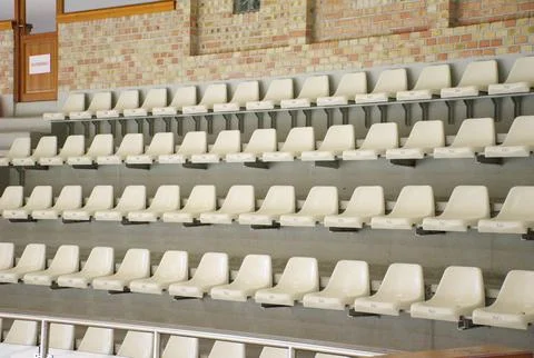 Empty white stadium seats in rows indoor stadium Stock Photos