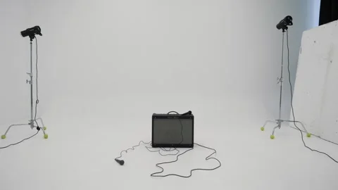 Empty white studio with microphone and subwoofer on the floor Video stock 240734231