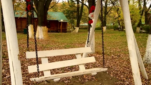 Empty white swing in the courtyard Video stock 272298451