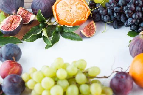 Empty white table with orange tangerine, figs and grape fruit . Healthy foo.. Stock Photos