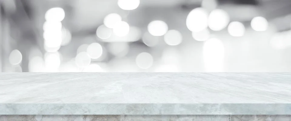 Empty white table top, counter, desk over blur perspective store with bokeh l Stock Photos