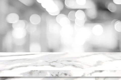 Empty white table top, counter, desk over blur perspective store with bokeh l Stock Photos