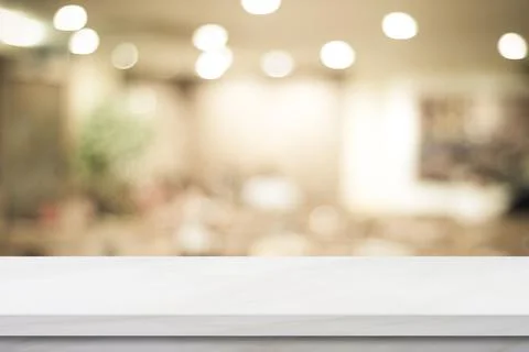 Empty white table top, counter, desk over blur perspective store with bokeh l Stock Photos