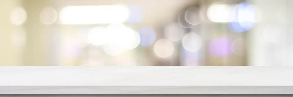 Empty white table top, counter, desk over blur perspective store with bokeh l Stock Photos