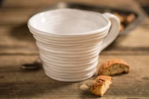 Empty White Teacup Between Spoon and Biscuits Stock Photos