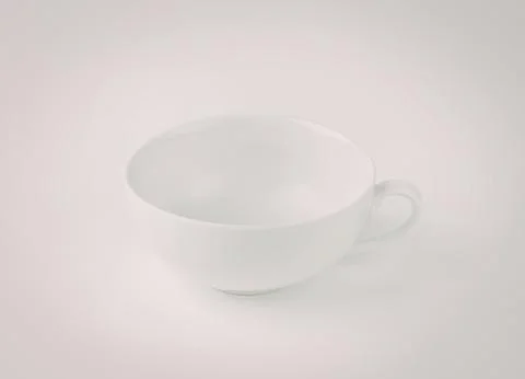 Empty white teacup with saucer on table Stock Photos