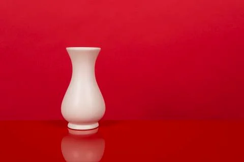 Empty white vase, on a red design interior Stock Photos