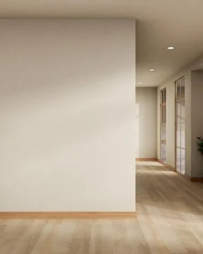 Empty white wall over wooden parquet floor with sunlight through window in .. Ilustración de archivo