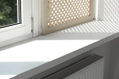 Empty white window sill and decorative wooden shutter indoors Stock Photos