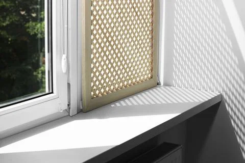 Empty white window sill and decorative wooden shutter indoors Stock Photos