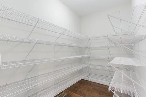 Empty White Wire Shelving In A Walk-In Pantry With Hardwood Floors And Whit.. Stock Photos