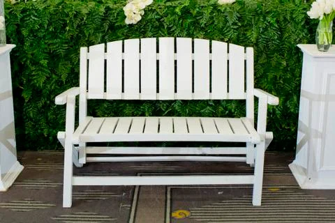 Empty white wooden bench in yard Stock Photos
