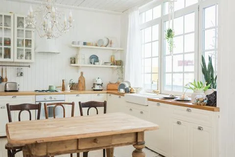 Empty white wooden kitchen interior with dining room. Scandinavian classic mi Stock Photos
