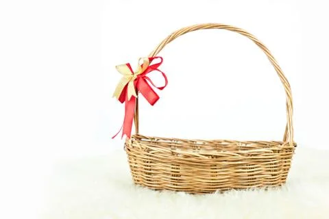 Empty wicker basket with red and gold ribbon isolated on white background Stock Photos