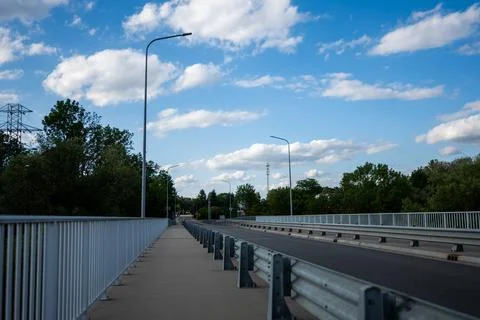 Empty wide road bridge with crash barriers and tall street lamps Foto stock
