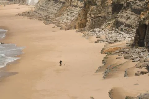 Empty wild sand beach with cliffs Stock Photos