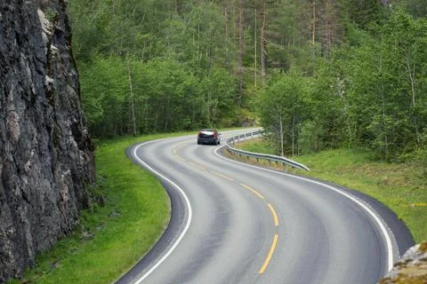 Empty winding forest road Stock Photos