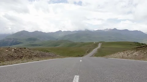 Empty winding motor road in the mountains in cloudy weather Stock Footage 166548389