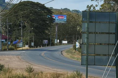 Empty winding road passing through trees growing at Costa Rica Stock Photos