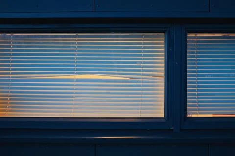 Empty window with blinds and peephole at night Stock Photos