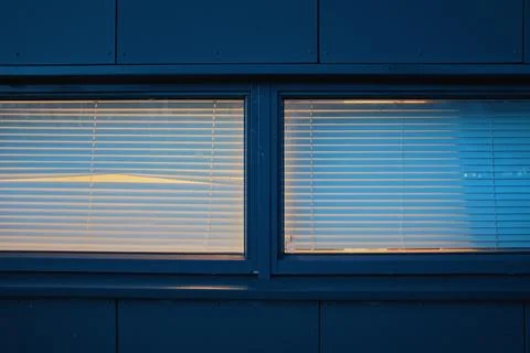 Empty window with blinds and peephole at night Stock Photos