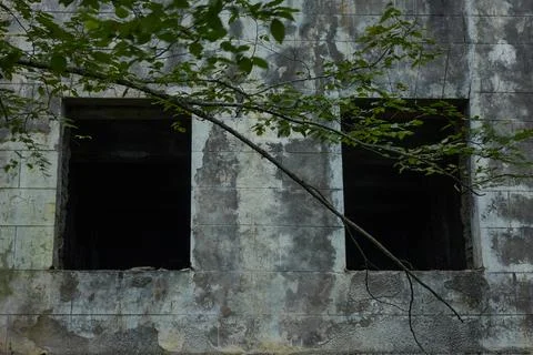 Empty window frames in an old abandoned restaurant building. Stock Photos