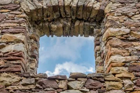 Empty window hole giving view to blue sky Stock Photos