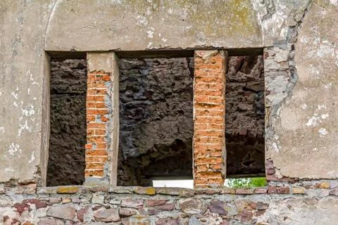 Empty window hole giving view to ruins Stock Photos
