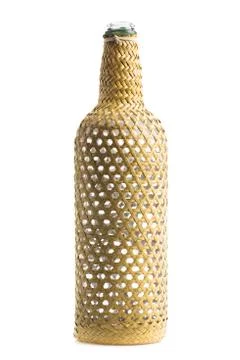 Empty wine bottle, braided dry grass traditional hand made isolated on white Stock Photos